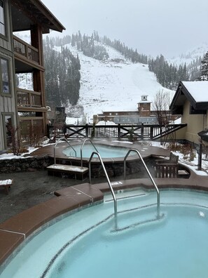 A pool area with a view of a snowy mountain.