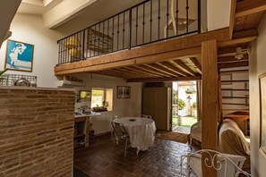 Enjoy meals or gatherings at the round dining table, with a serene garden view from the balcony.