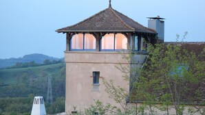 A tower-like structure with a tiled roof and a small window.