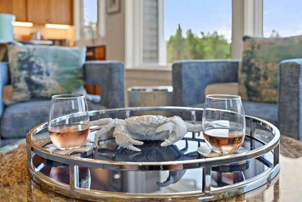 A dining table with two glasses of wine and a decorative crab shell centerpiece.