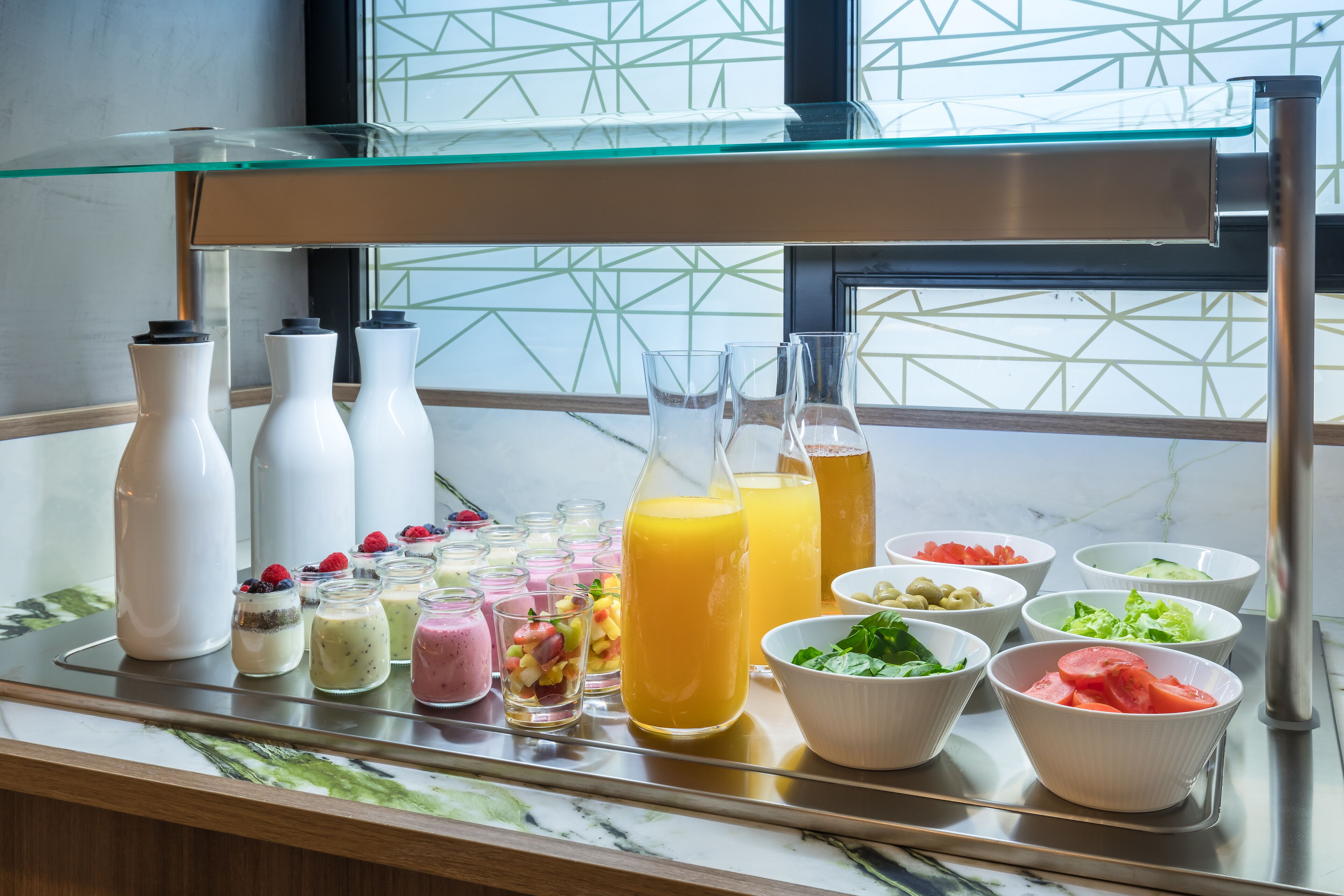 A breakfast buffet with various food items and beverages.