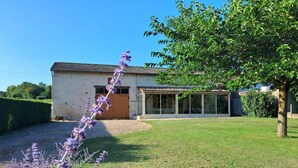 A house with a tiled roof, a large glass door, and a grassy yard. - Le Charneron - Chardonnay (CHARDONNAY)
