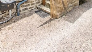 A stone building with a wooden staircase leading to a door. - Le Verger - Paris L'hopital (PARIS L'HOPITAL)