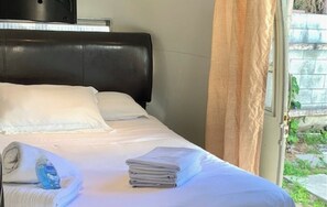 Enjoy a restful night's sleep in this inviting room with a comfortable bed and a window offering a view of the outdoors.