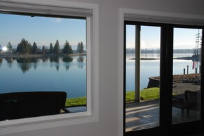 Relax in a serene space with a view of the calm lake surrounded by trees.