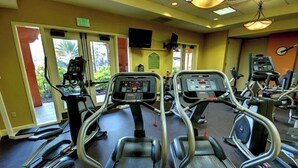 A gym with treadmills, ellipticals, and exercise bikes.