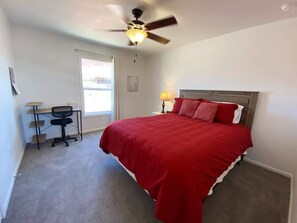 A bedroom with a bed, a desk, a chair, a ceiling fan, and a window. - 3BR Family Home | Red Rock Views+Stargazing (Kanab)