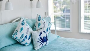 A bedroom with a bed, two wall-mounted lamps, and a window with blinds. - Star of the sea Guest house, Sea Forever King size bed with ocean view balcony! (White Rock)