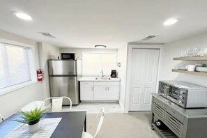 Fridge, microwave, coffee/tea maker, cookware/dishes/utensils