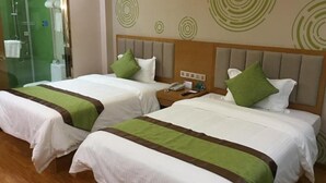 Two twin beds with green and brown bedspreads, a wooden headboard, and a nightstand with a phone. - Greentree Inn (Suqian)