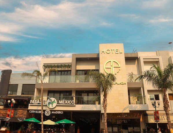 A hotel with a prominent 'HOTEL' sign, a 'GRAN PLAZA' sign, and a 'MEXICO' sign. - Hotel Grand One Plaza (Tijuana)