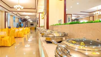 A buffet setup with multiple serving stations and a long counter.