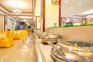 A buffet setup with multiple serving stations and a long counter. - Vienna Hotel (Fengshan) (Fengshan)