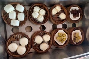Varie pietanze in cesti di legno, probabilmente in una cucina o area di preparazione cibi.