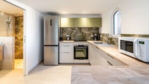 A modern kitchen with a built-in oven, a microwave, and a refrigerator. - Lower villa refurbished, air conditioning and terrace with sea view (ST MANDRIER SUR MER)