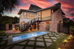 Enjoy a backyard with a swimming pool, stone pathway, and lawn.