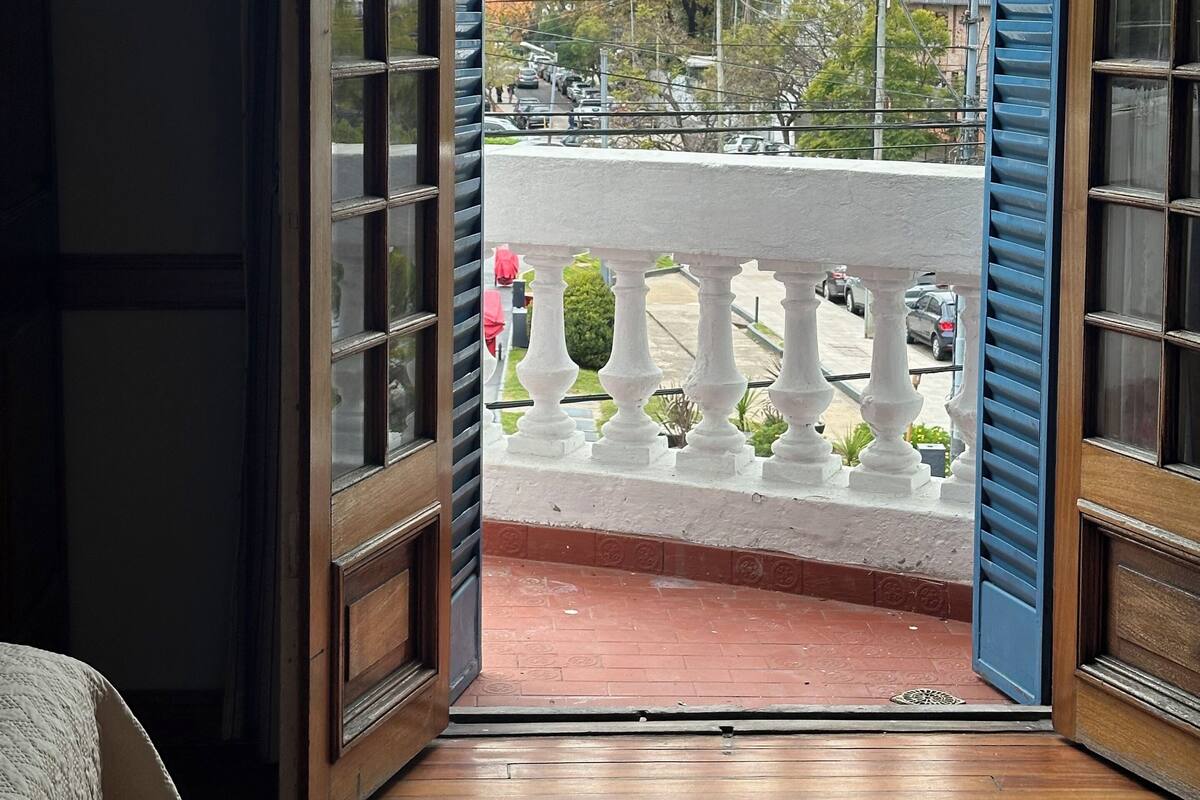 A balcony with a view of a street and buildings.