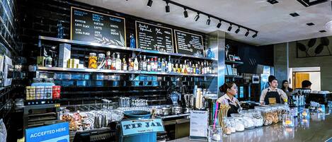 A bar with a menu board, a tip jar, and a QR code for payment.