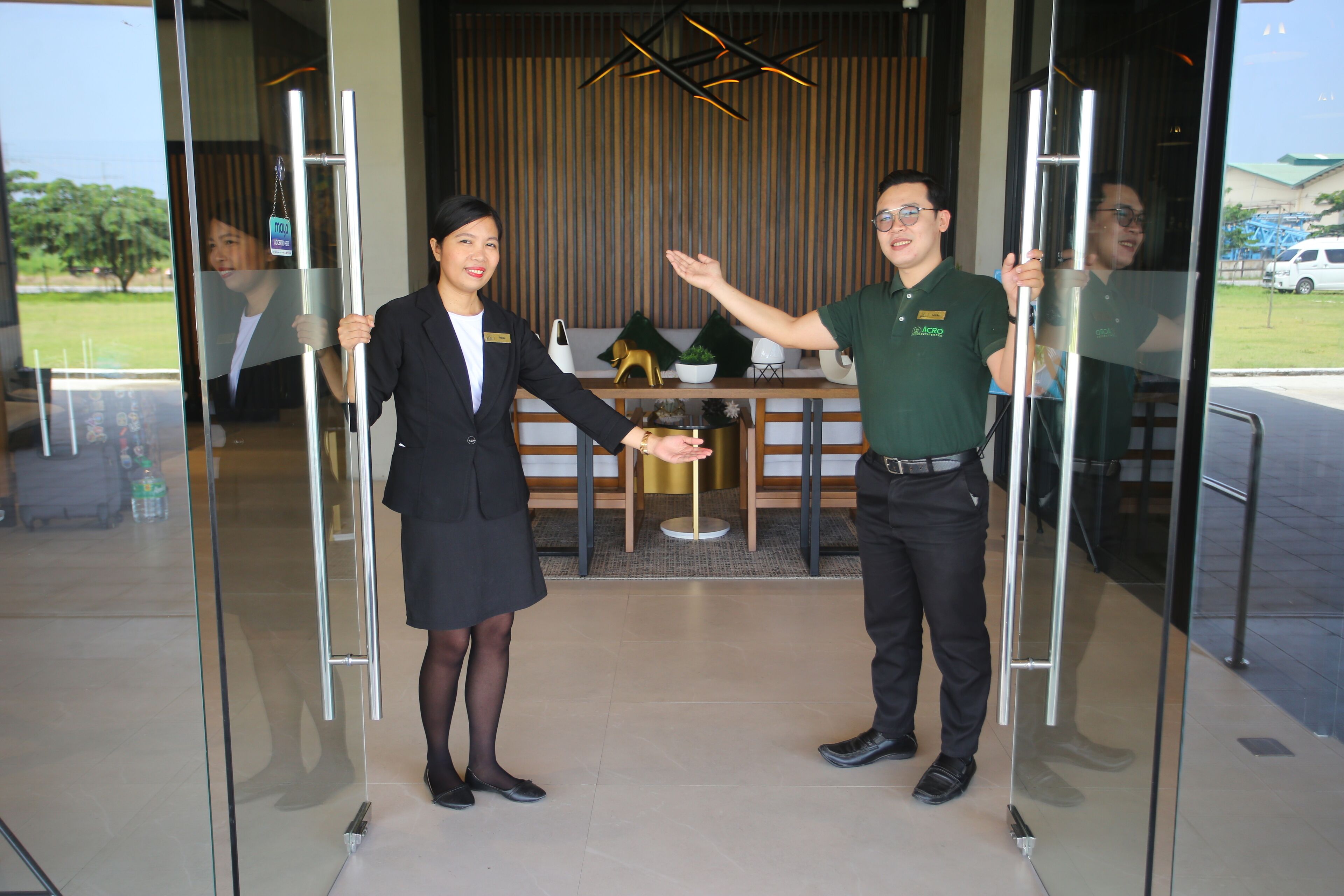A reception area with a modern interior, including a reception desk, a plant, and a decorative gold-colored object.