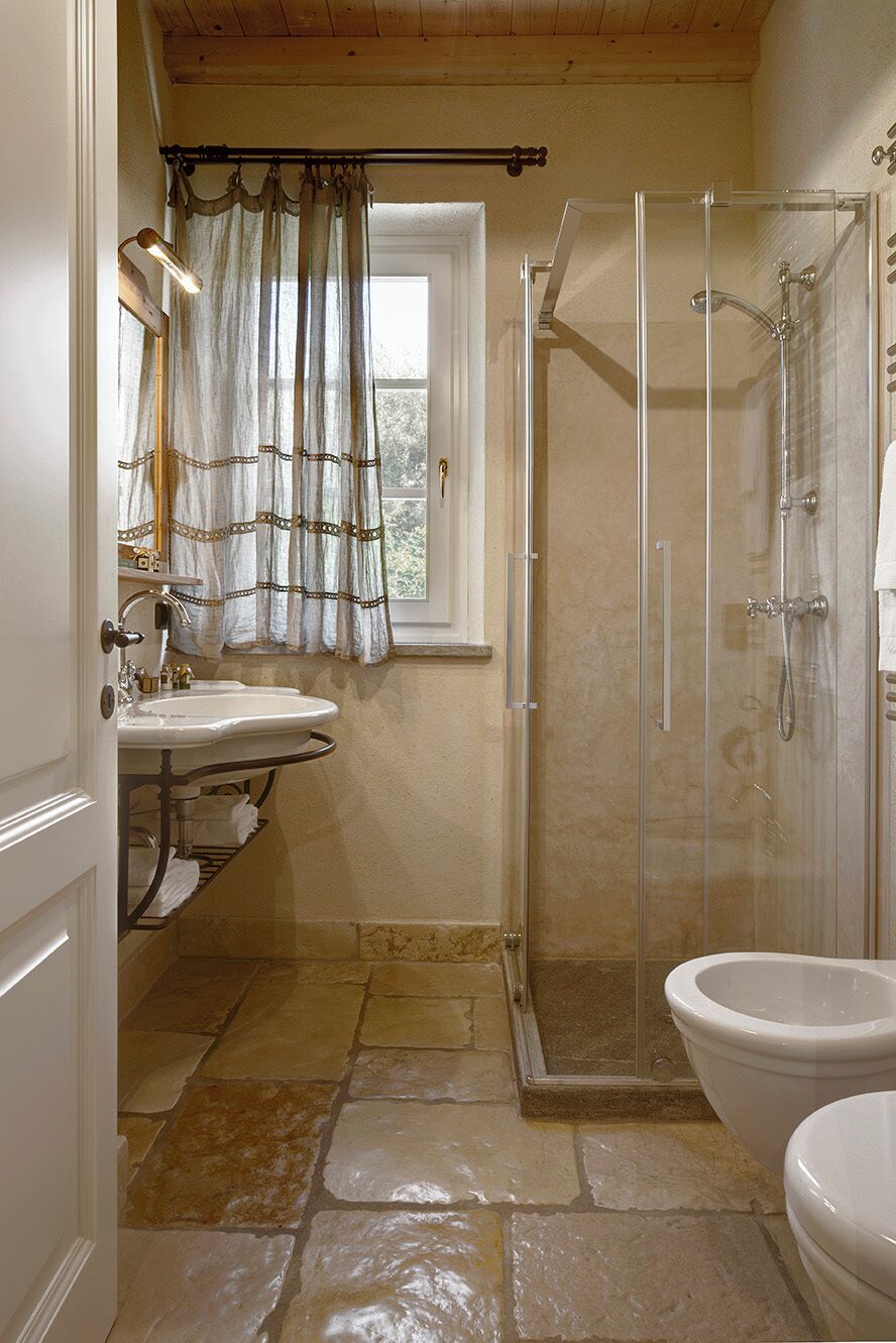 A bathroom with a shower, a sink, and a toilet.