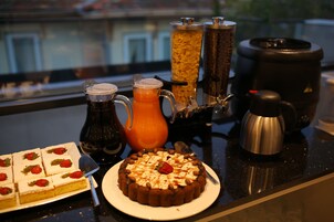 A breakfast buffet with various food items and beverages.