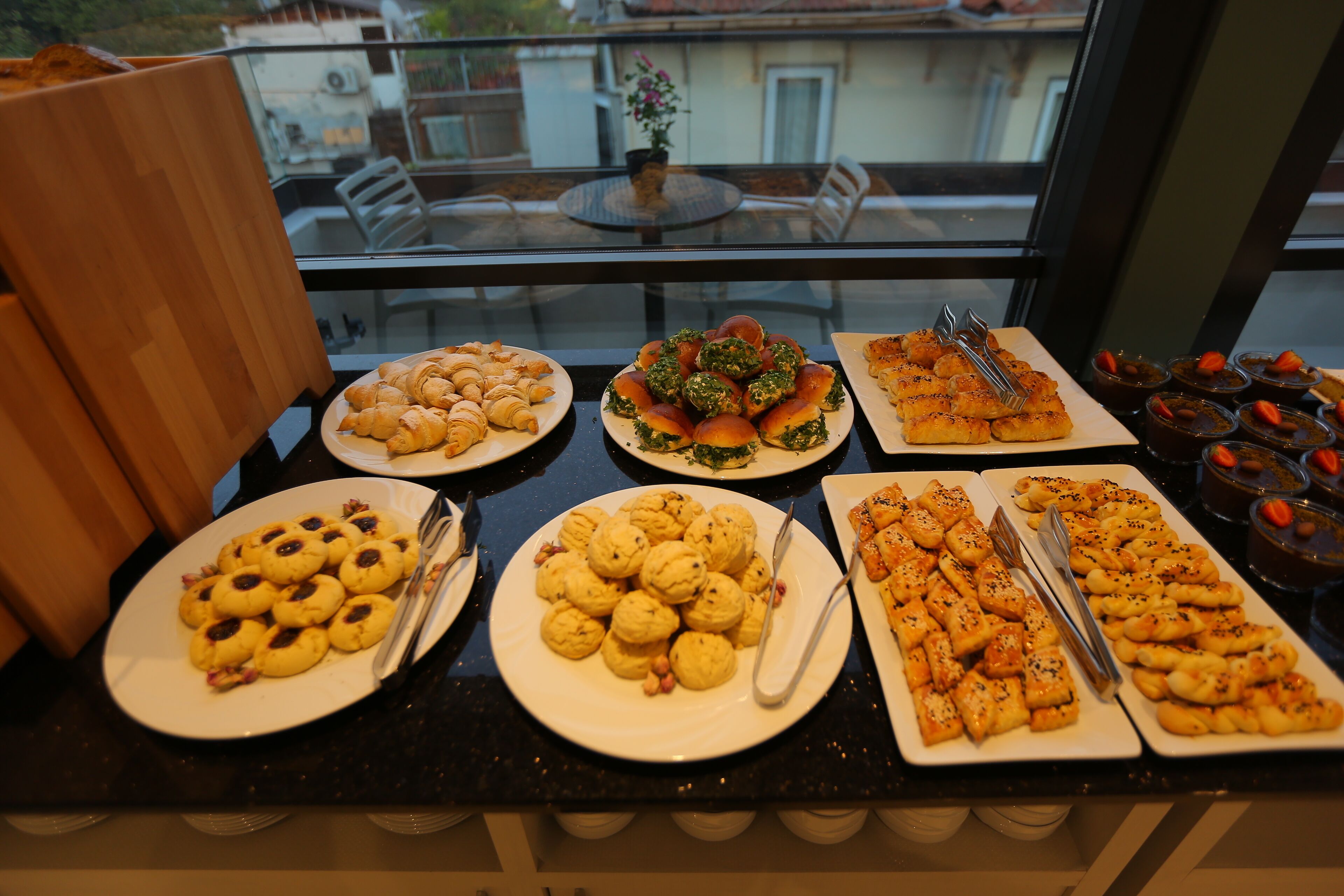 A buffet table with various food items.