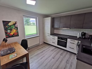 Fridge, stovetop, dishwasher, coffee/tea maker