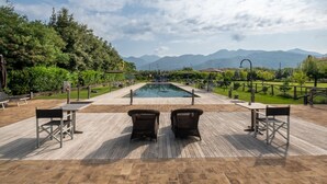 A pool area with a view of mountains, surrounded by greenery and furnished with outdoor seating. - Olimagio Farmstay w/animals & 25m pool <4km Forte dei Marmi beach (Pietrasanta)