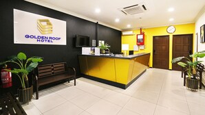 A reception area with a counter, a bench, and a sign for the Golden Roof Hotel. - Golden Roof Hotel Falim Ipoh (Ipoh)