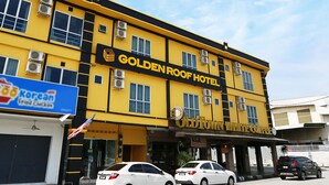 A hotel with a yellow facade, multiple air conditioning units, and a sign for 'Golden Roof Hotel'. - Golden Roof Hotel Falim Ipoh (Ipoh)