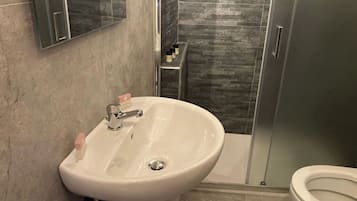 Een douche, een haardroger, een bidet, handdoeken