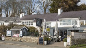 A traditional building with a sign reading "The Boat House" and "Cafe & Restaurant". - 2 The Coach House (Pentraeth)