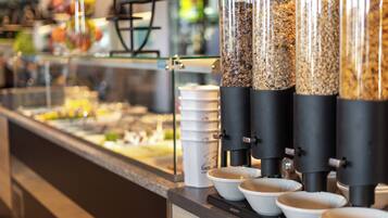 A coffee station with multiple dispensers and cups.