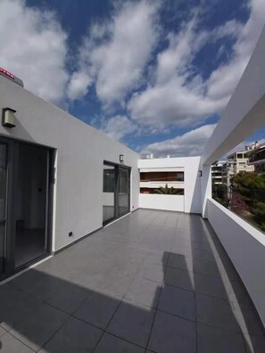 A modern outdoor balcony with a clear sky. - GTD35501 - Unique Villa in Voula Riviera (Vari-Voula-Vouliagmeni)