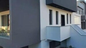 A modern building with a flat roof, large windows, and a minimalist design. - GTD35501 - Unique Villa in Voula Riviera (Vari-Voula-Vouliagmeni)