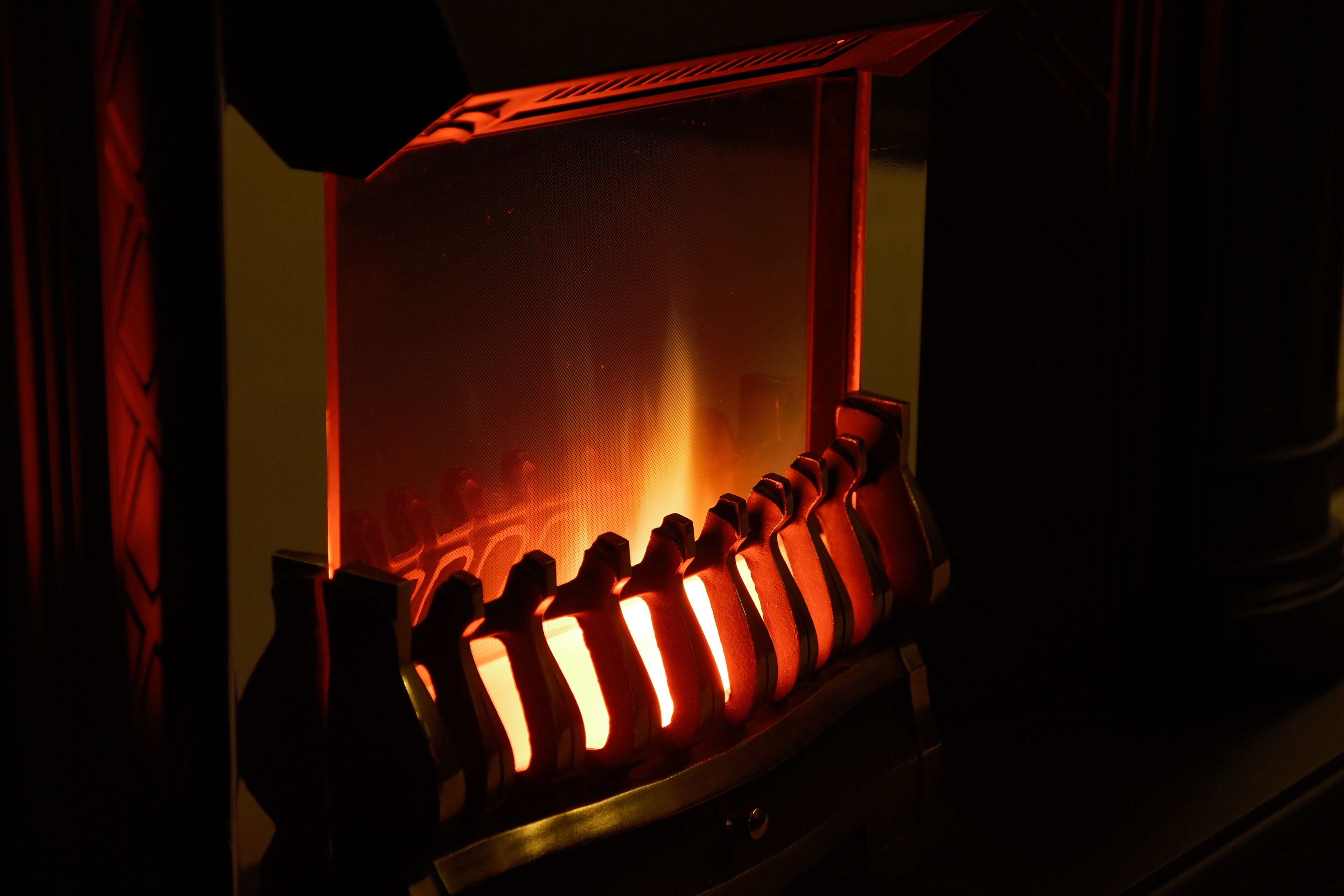 A close-up of a red-lit heating element, likely part of a heating system.