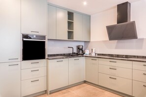 Fridge, stovetop, dishwasher, coffee/tea maker