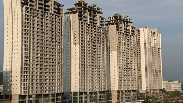 A multi-story residential building with a modern architectural design, featuring a grid-like facade and multiple balconies. - S&A Property 4 (Citaringgul)