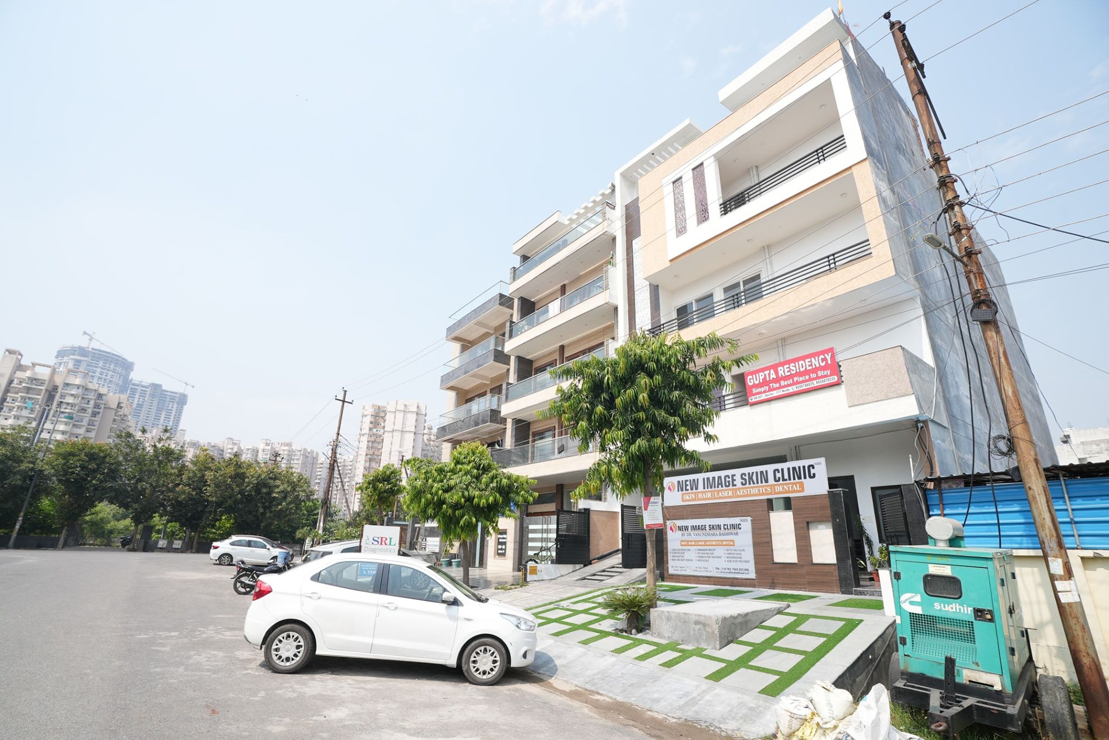 A multi-story building with a sign for 'New Image Skin Clinic' and 'Gupta Residency'.