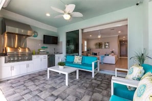 Enjoy cooking in the well-equipped kitchen with a stove and range hood, and relax in the adjacent seating area with a flat-screen TV.