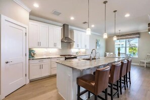 Enjoy cooking in this well-equipped kitchen with a central island and bar stools.