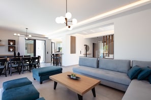 Relax in this stylish living space with a sofa, coffee table, and ottoman, perfect for unwinding and socializing.