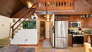 A modern kitchen with stainless steel appliances, wooden cabinets, and a built-in microwave. - Zen Escape : Game Room : Hot Tub (Albrightsville)