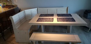 Enjoy meals in this cozy dining area with a table and cushioned bench.
