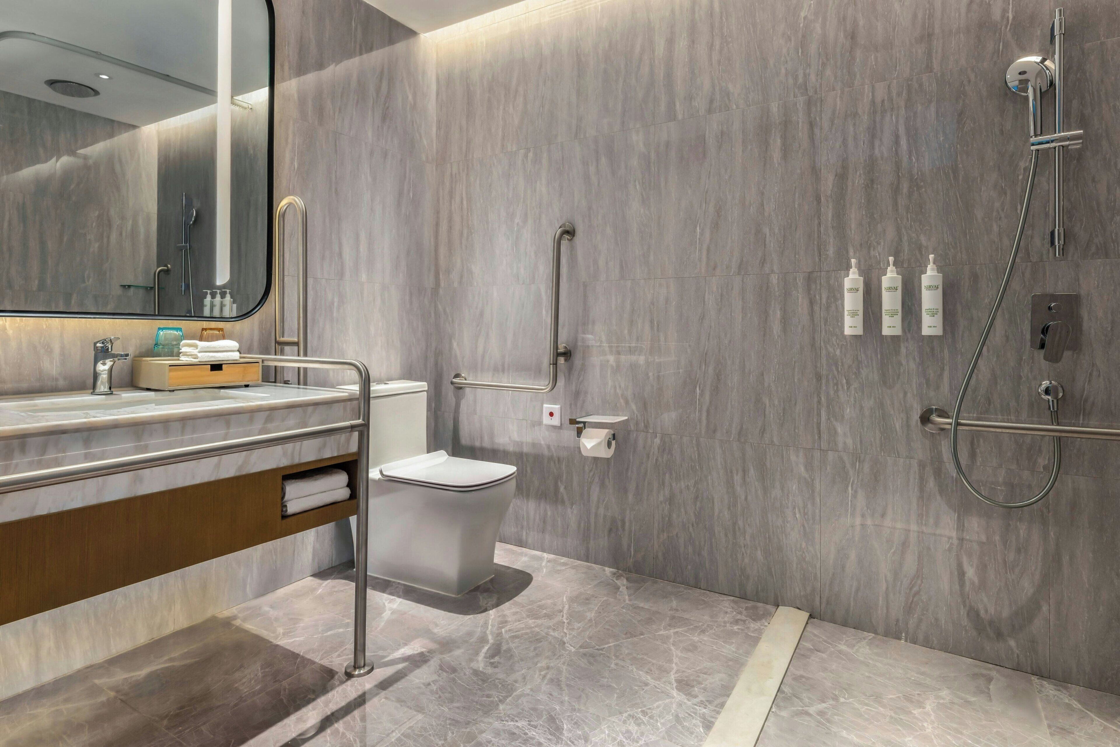 A modern bathroom with a toilet, bidet, and shower.