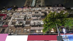 A multi-story building with balconies, a tree in the foreground, and a sign for "SHOE GAZA". - Itsy Hotels Heraa International (Mumbai)