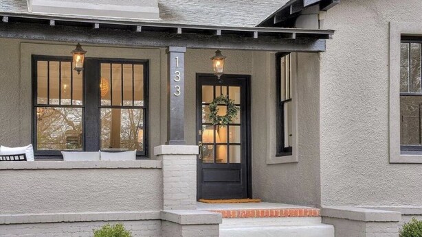 A house with a black front door, a number '133' on the wall, and a small porch with steps. - Historic charm near downtown/Bruce's Field (Aiken)