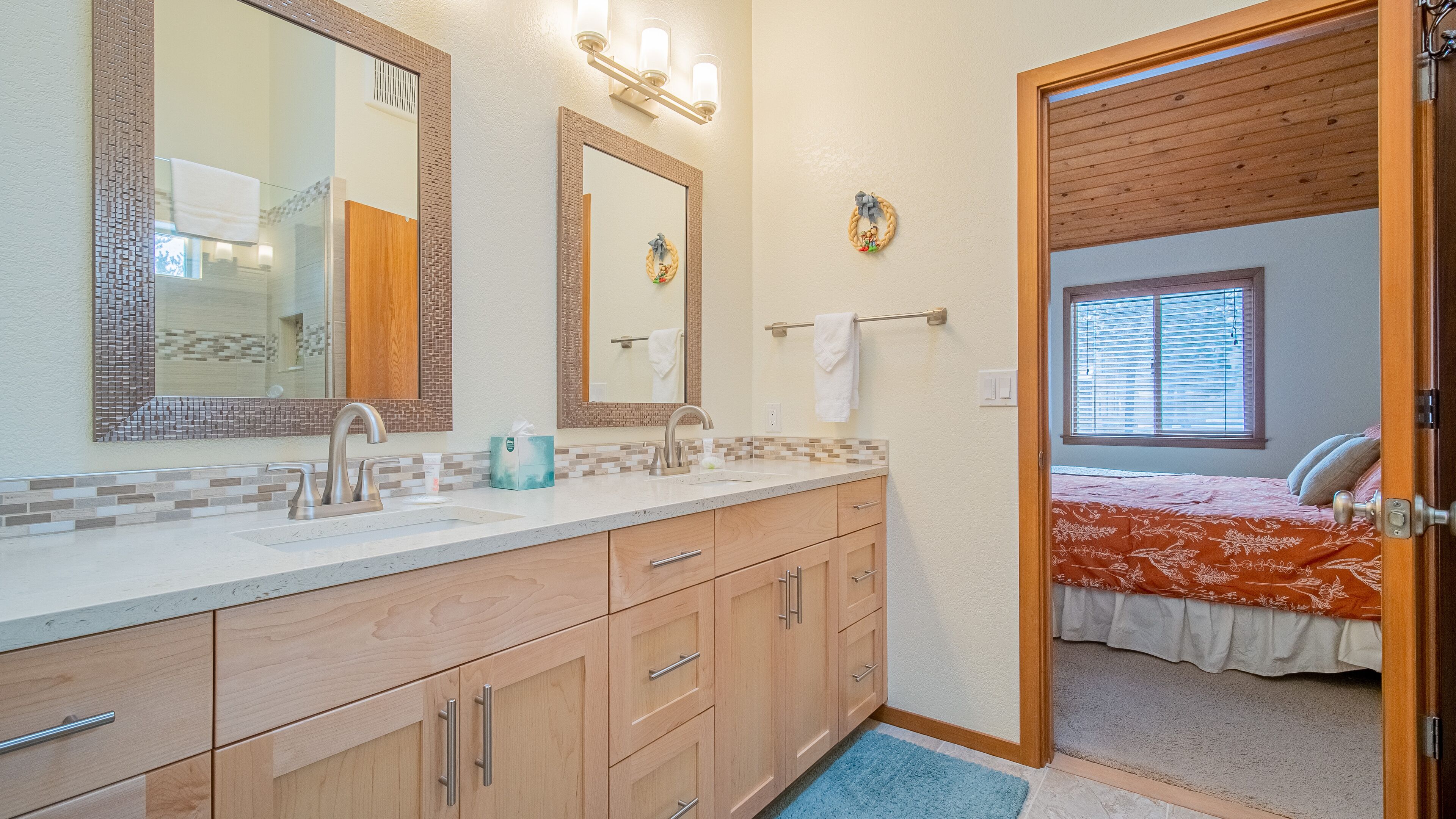 A bathroom with a sink, two mirrors, and a towel rack.