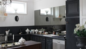 Una cocina moderna con armarios oscuros, lavavajillas y una ventana sobre el fregadero.