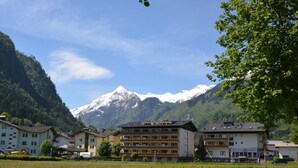 A hotel with multiple floors, a restaurant, and a view of snow-capped mountains.